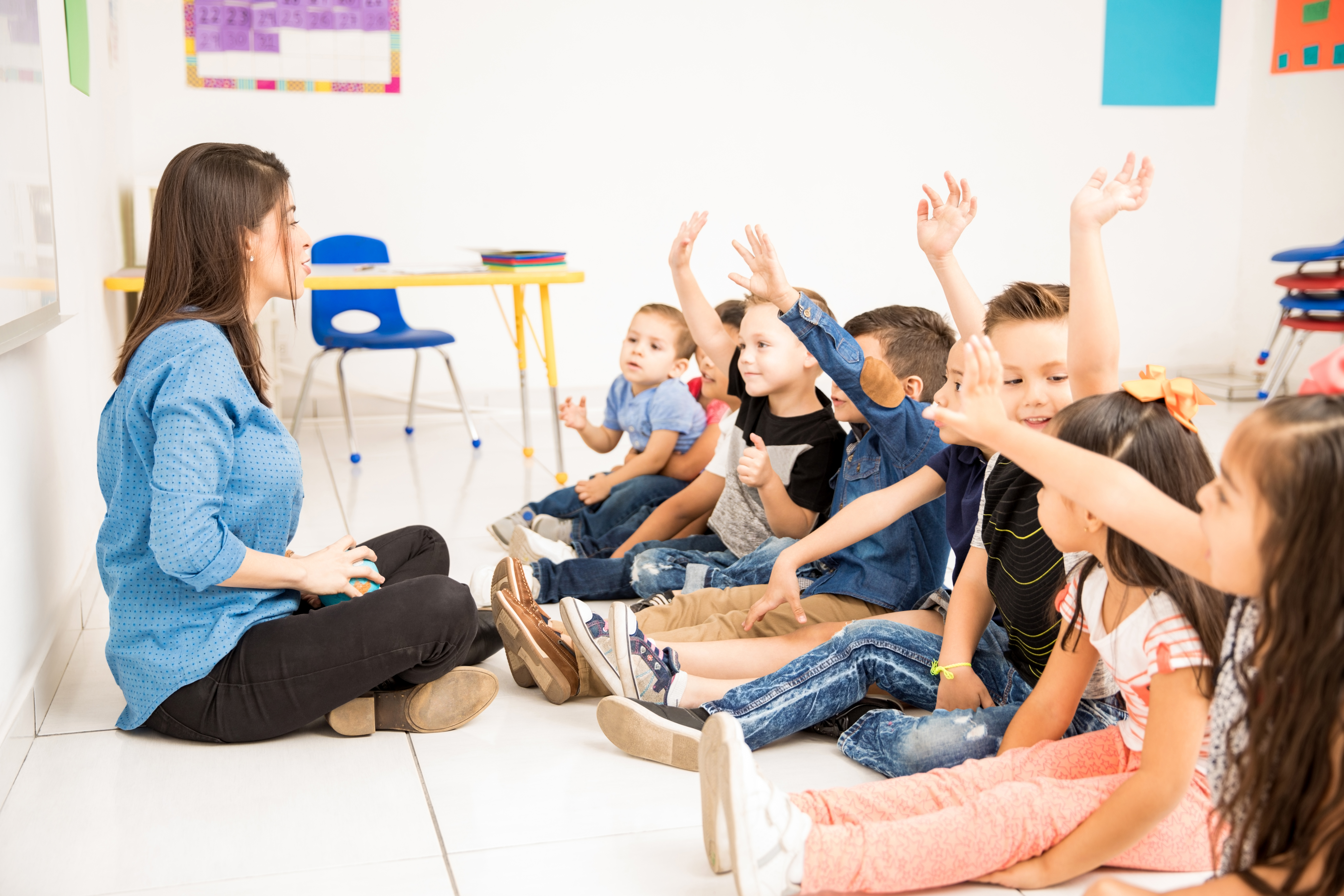 profile-view-of-group-of-preschool-students-raising-their-hands-and-trying-to-participate-at-school.jpg